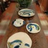 Four glazed earthenware plates
