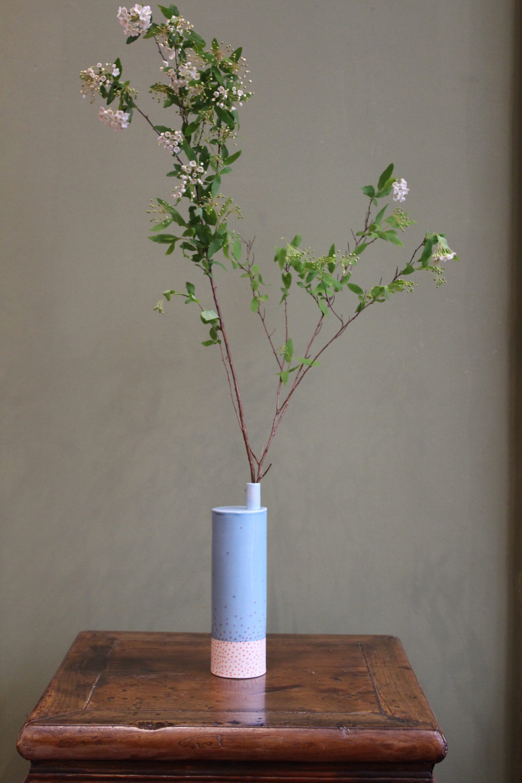 Enamelled porcelain can by Eric Hibelot Enamelled blue and white porcelain sprinkled with red dots.