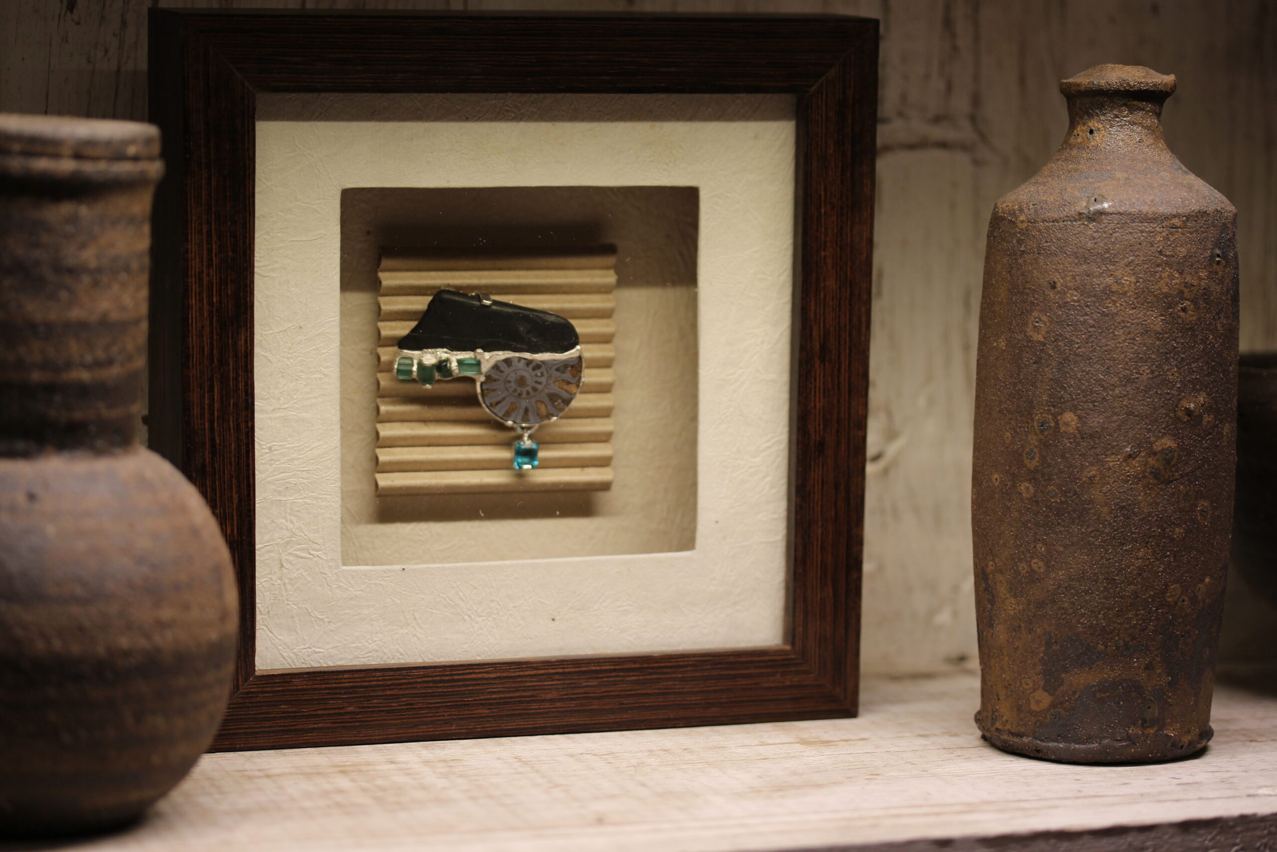 Black stone, amonite, tourmaline, apatite and silver brooch.