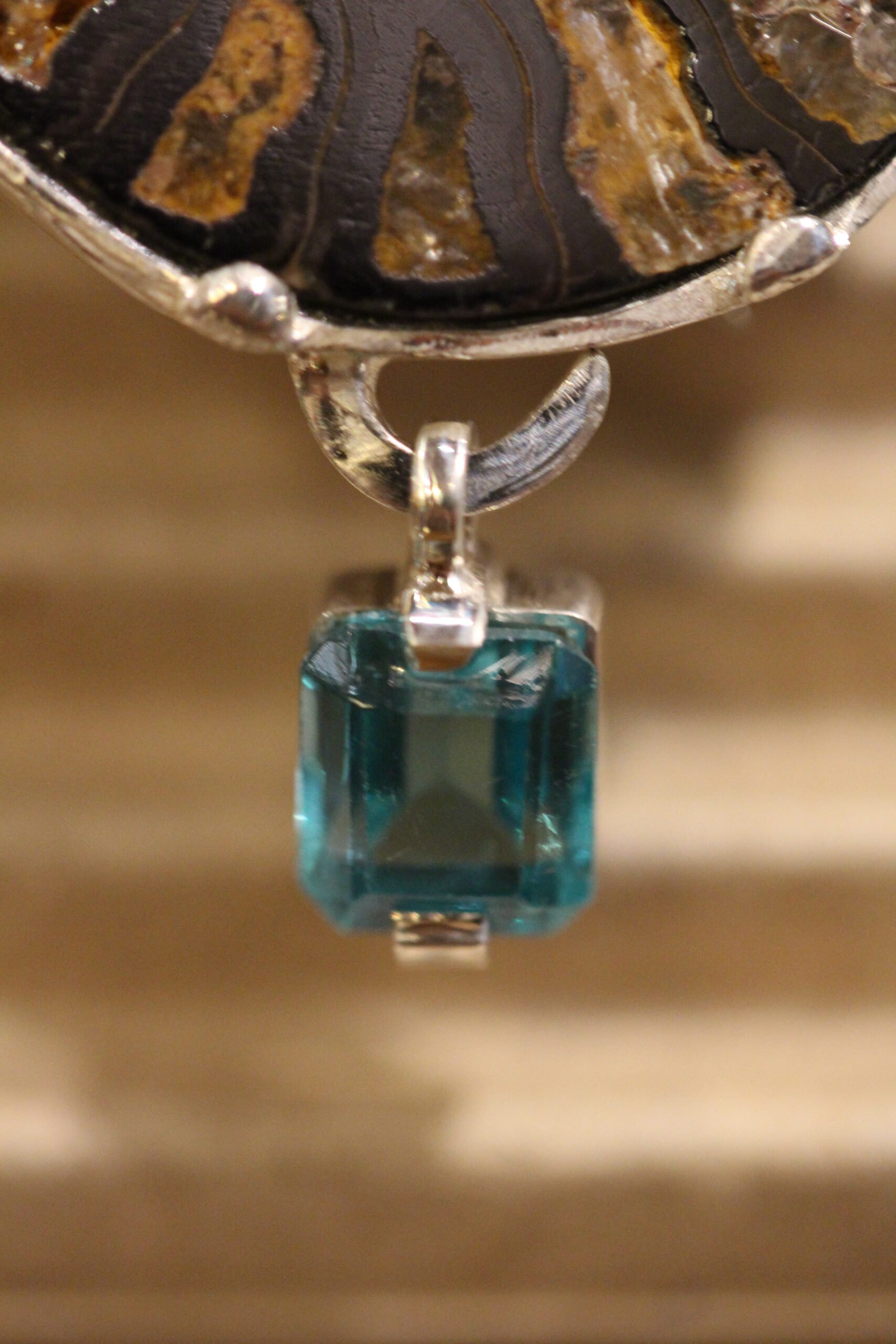 Black stone, amonite, tourmaline, apatite and silver brooch.