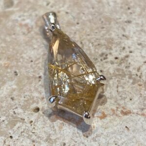 Sterling silver pendant with rutilated quartz.