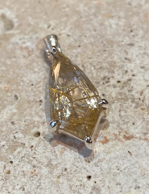 Sterling silver pendant with rutilated quartz.